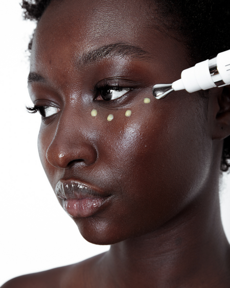 Image show's a model applying Eye Believe Eye Serum under the eye area.