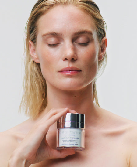 Woman Holding Night Duty Face Cream With Eyes Closed